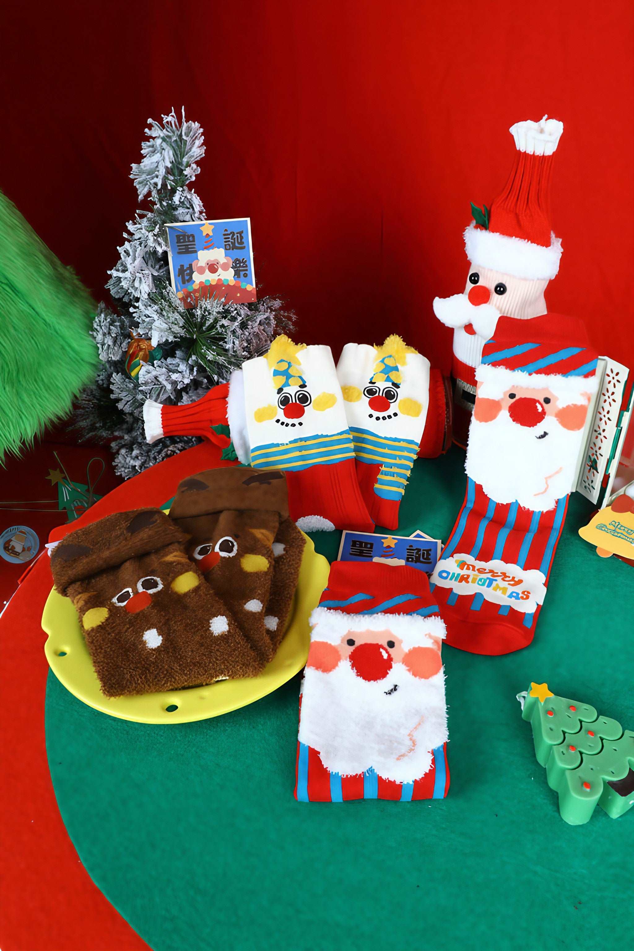 A Christmas-themed socks display on a table featuring a miniature tree and Santa ornament