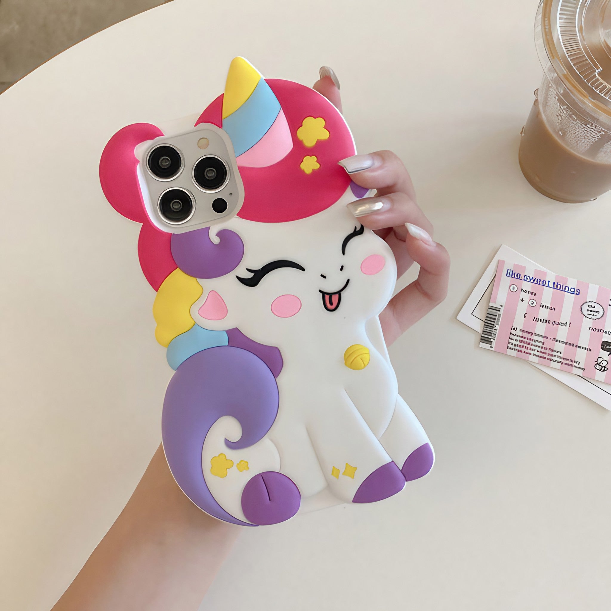 Close-up of a hand presenting a silicone unicorn iPhone case