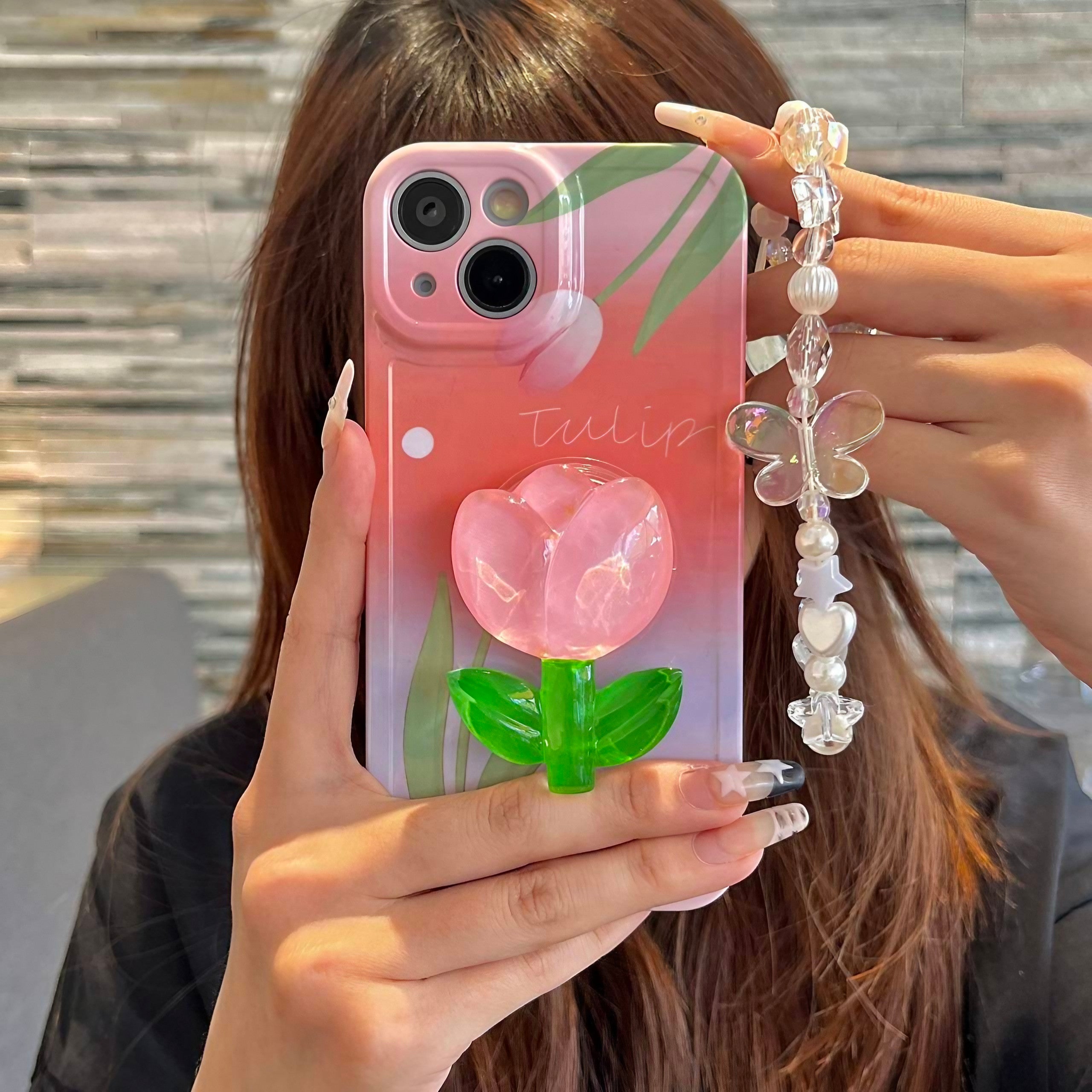 Close-up of the Pink Tulip iPhone Case with attached phone chain and stand for iPhone 14 series