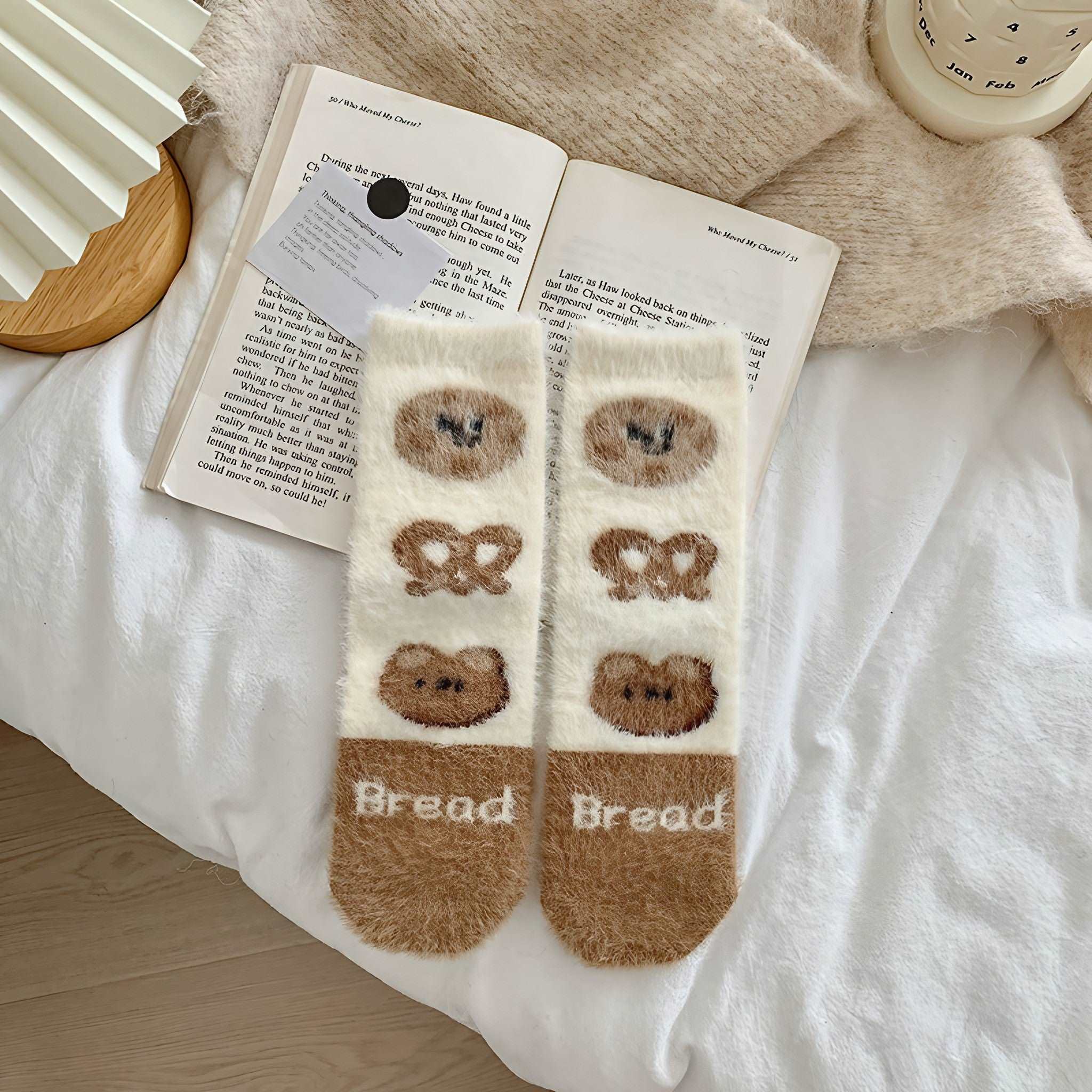 A cozy reading setup with a book and plush bear socks