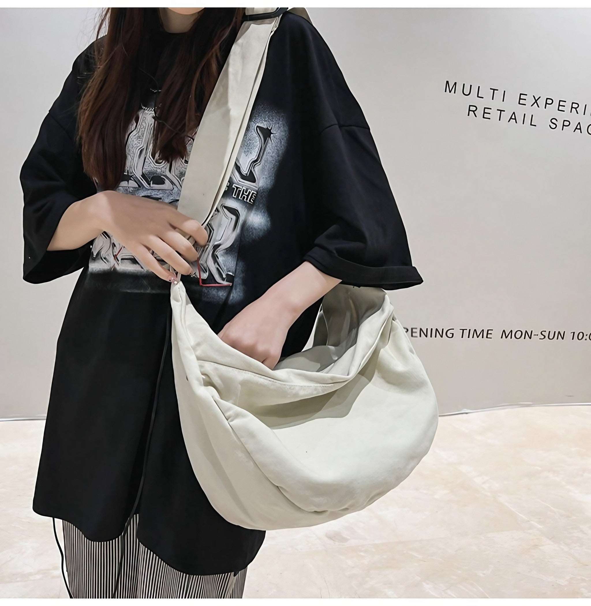 Lady presenting a chic grey canvas crossbody bag