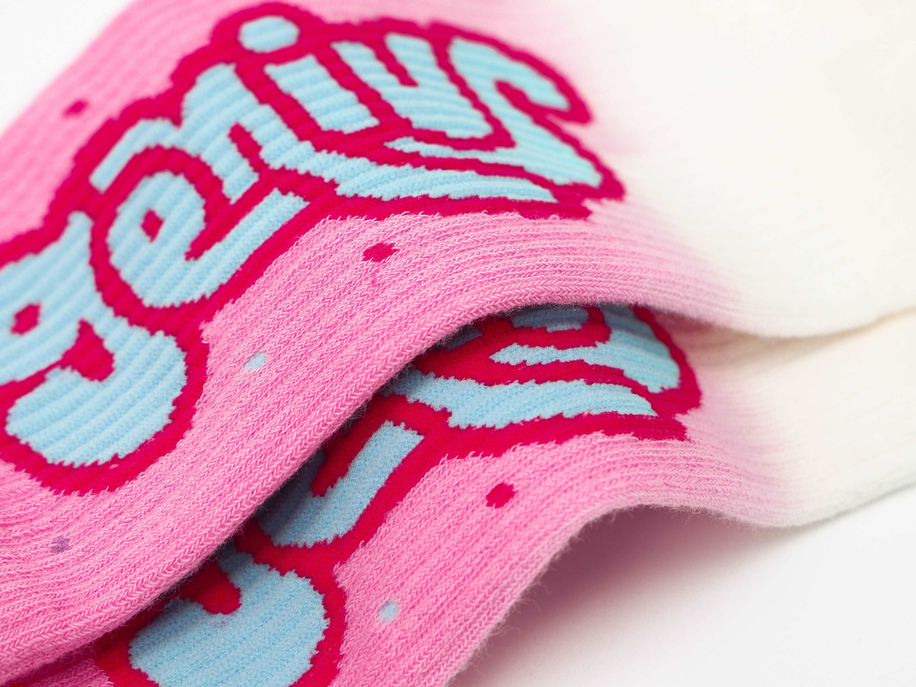 A single sock featuring the inscription 'genius' from the 1+2 Socks Set