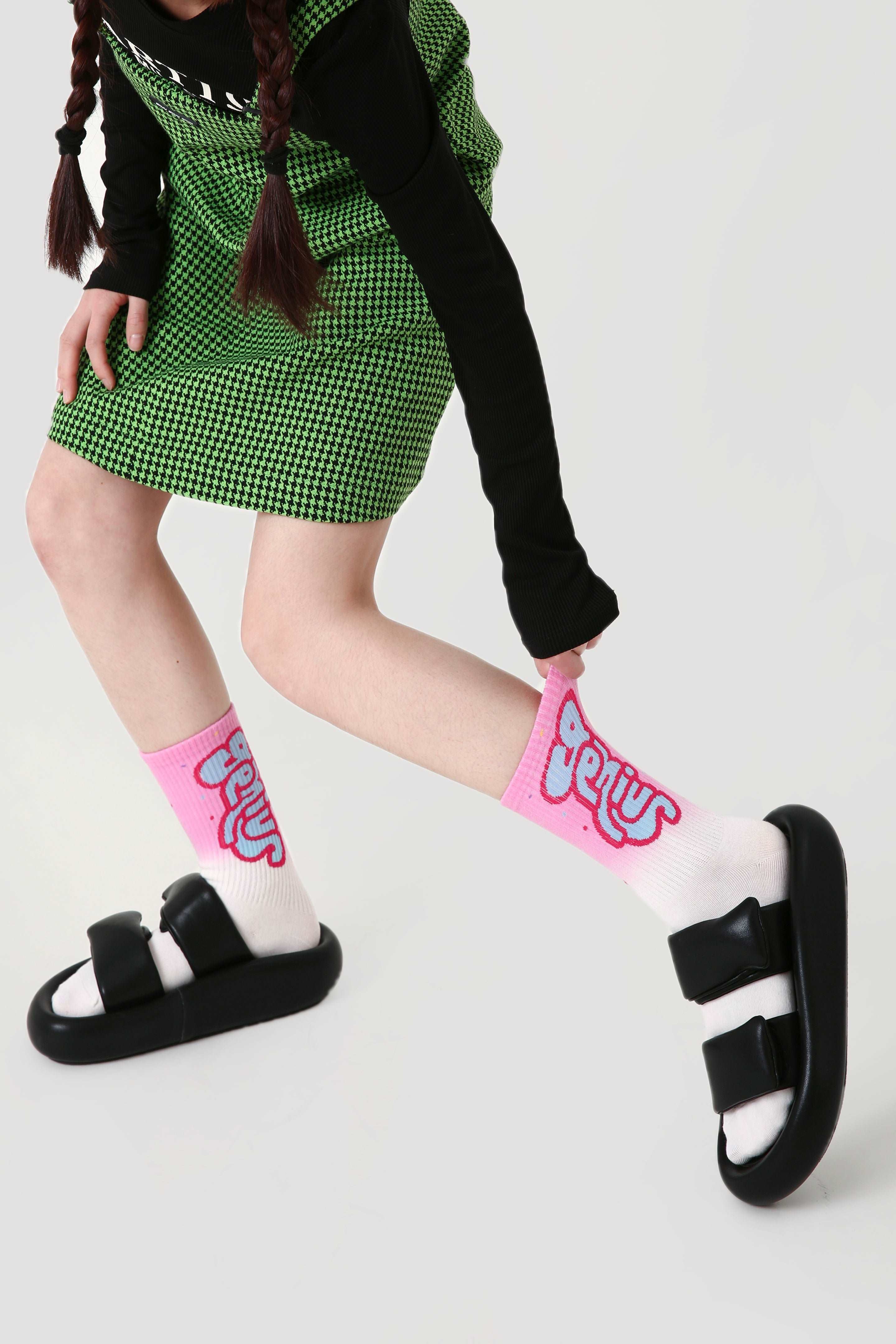 A close-up of a pink sock with a playful geometric pattern from the 1+2 Set