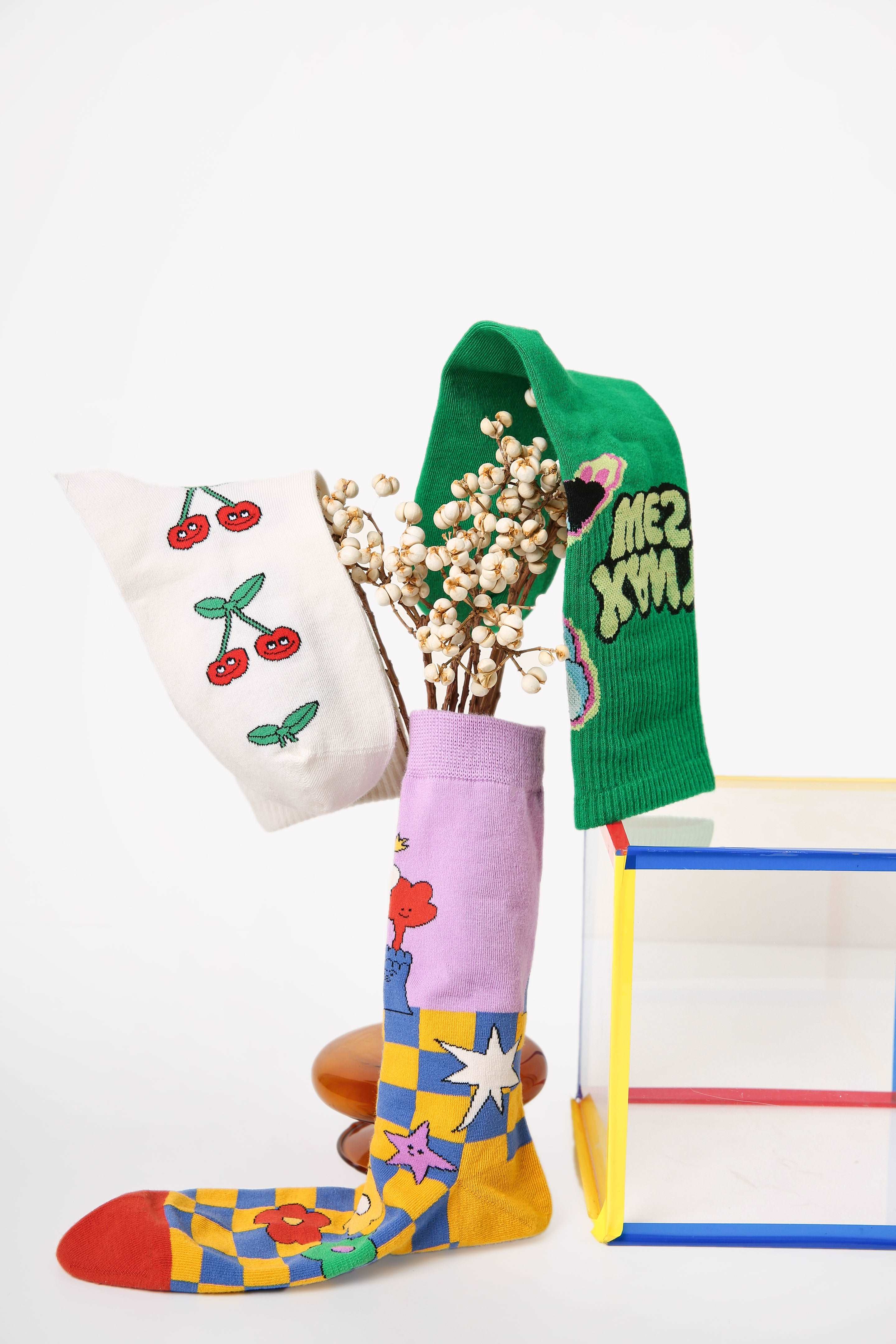 Creative presentation of the sock set with a vase and a floral arrangement