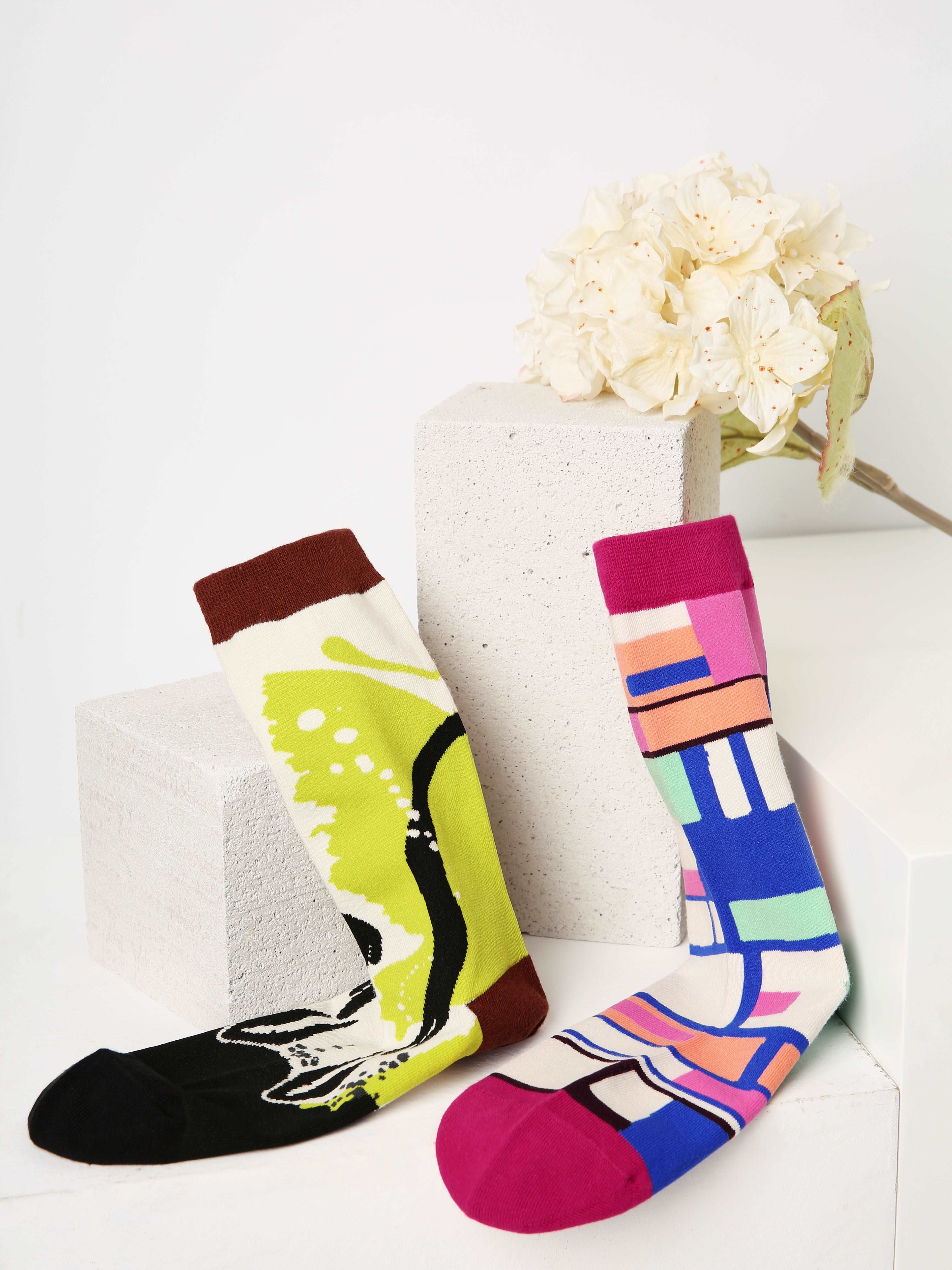 Two pairs of socks with vibrant, unique designs for the fall season