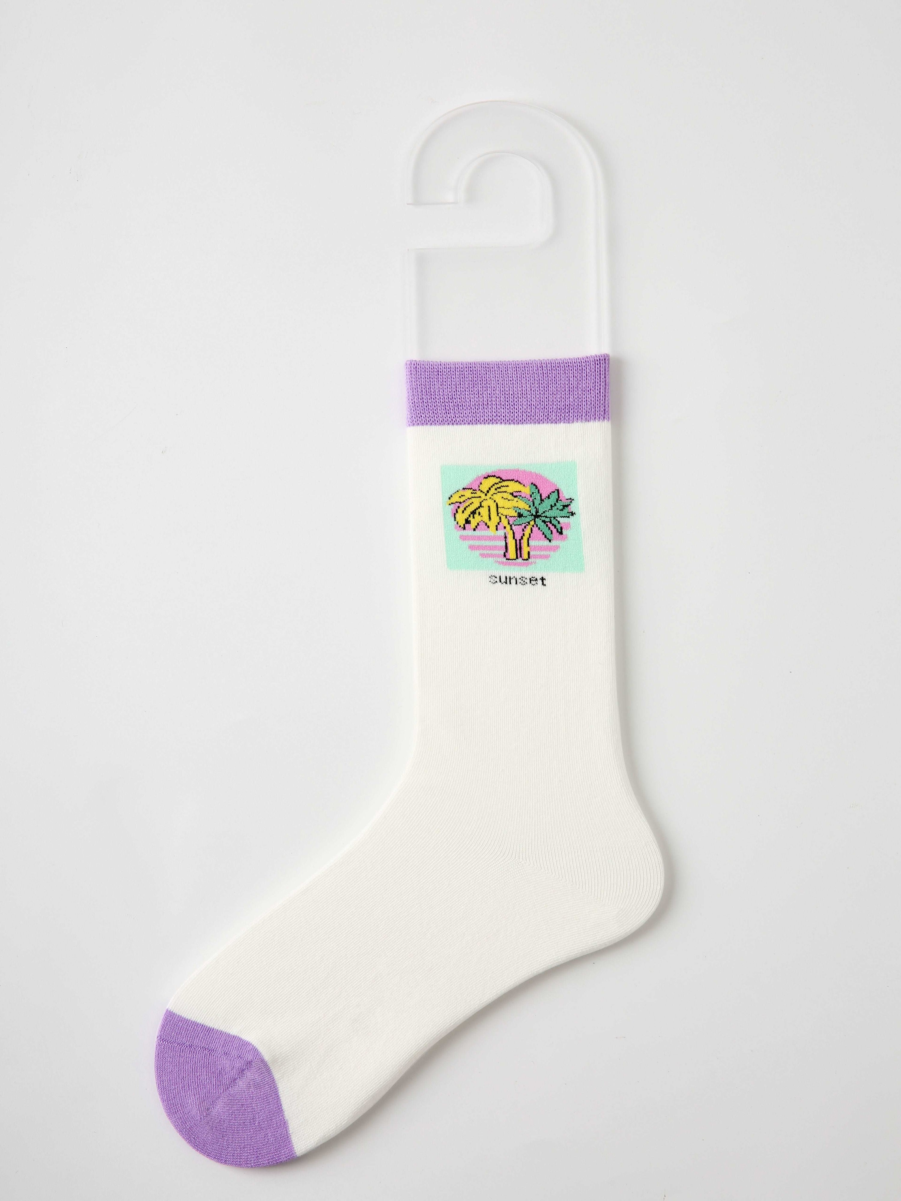 White sock with purple accents and a playful cartoon character