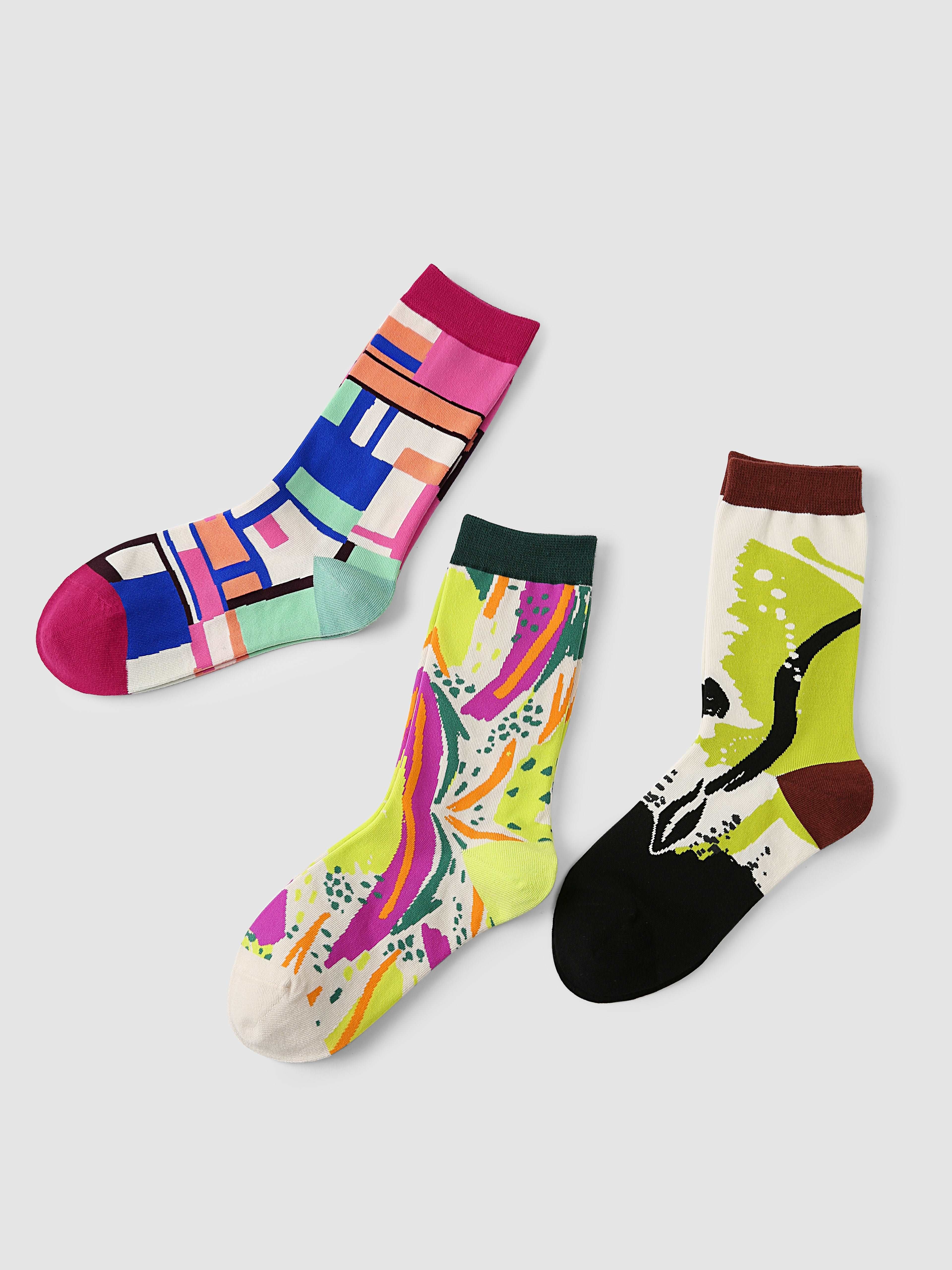 Trio of socks with diverse and colorful artistic patterns