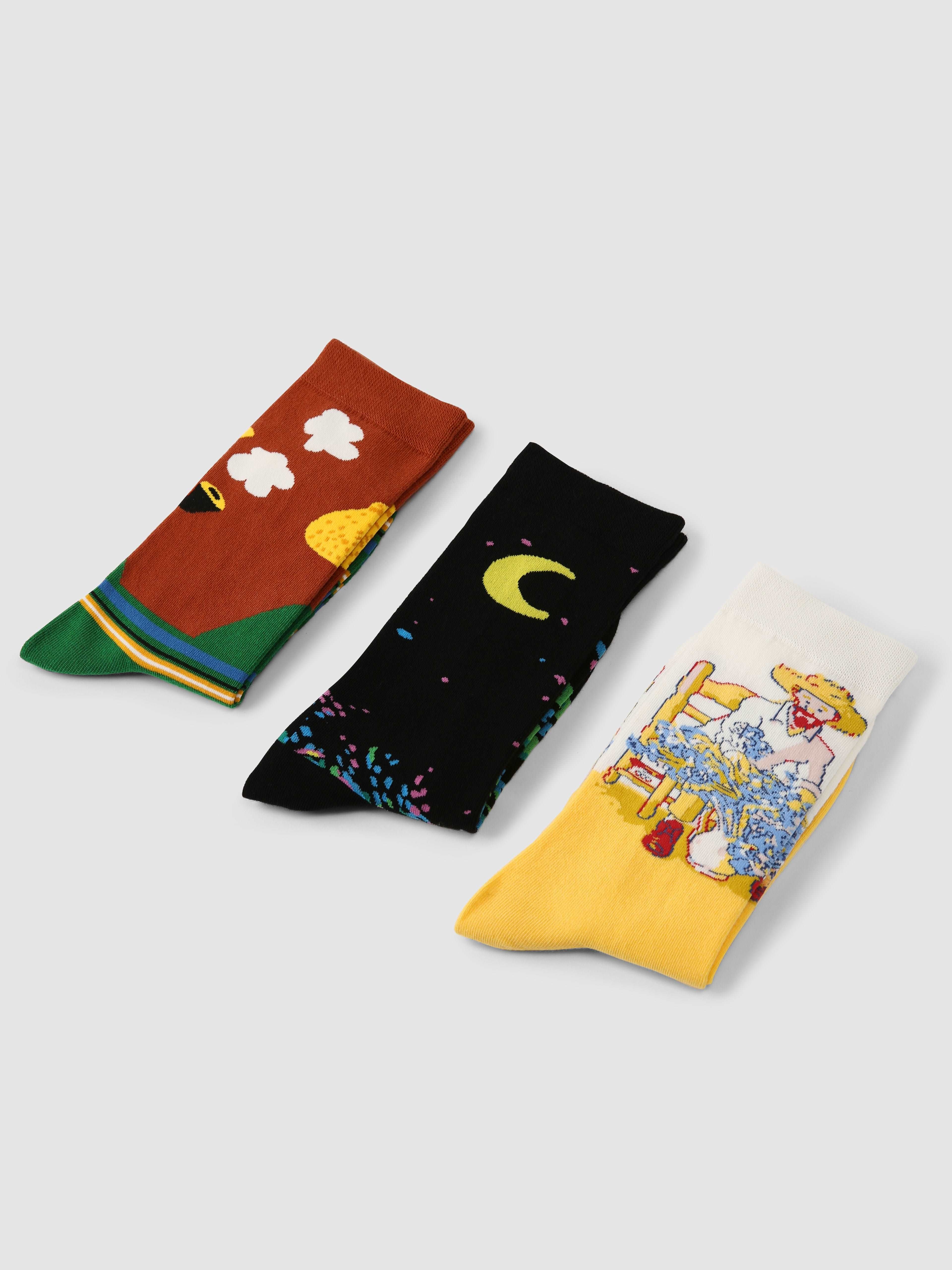 Trio of Starry Night themed socks with various cartoon illustrations