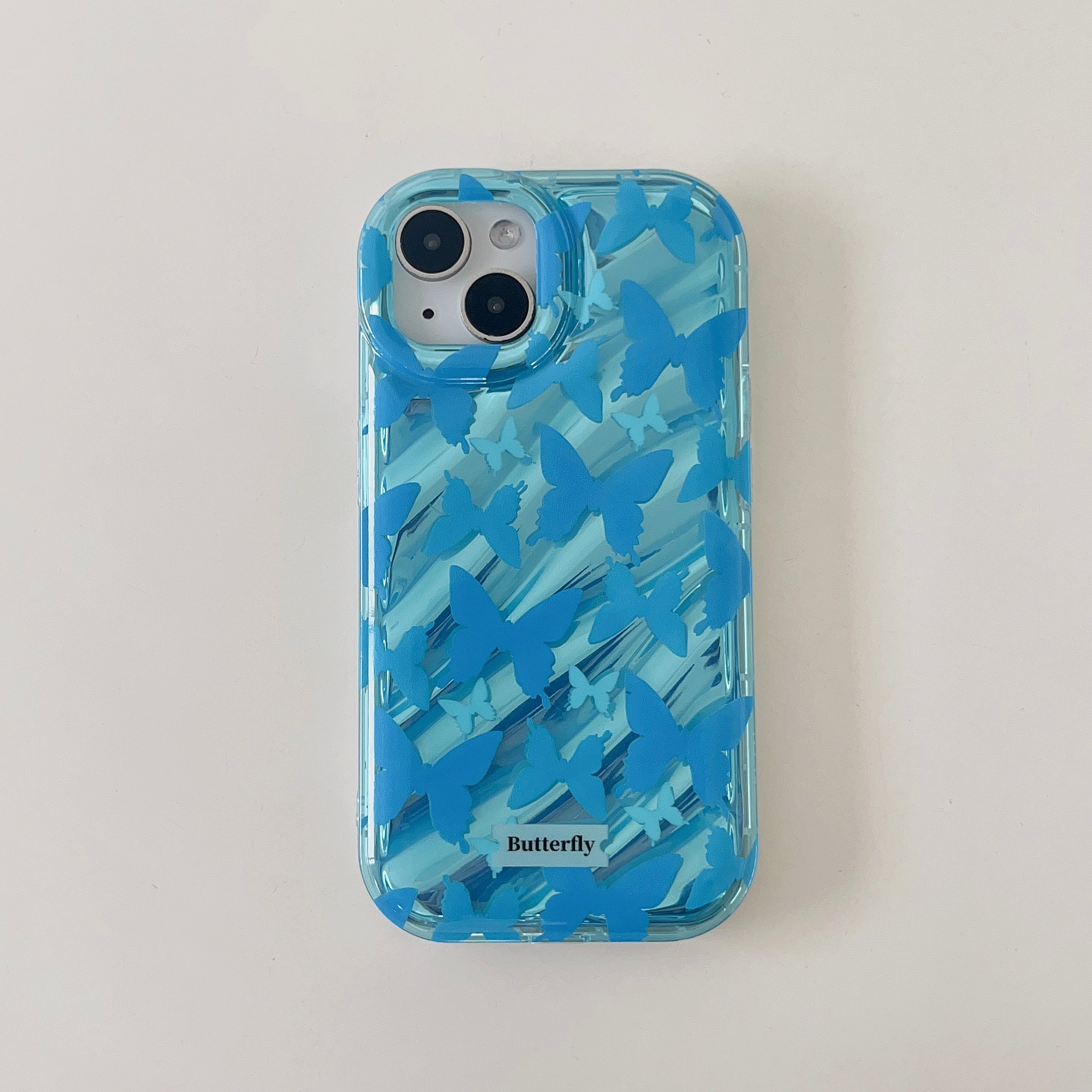 Close-up of an ice blue iPhone case featuring a delicate butterfly design