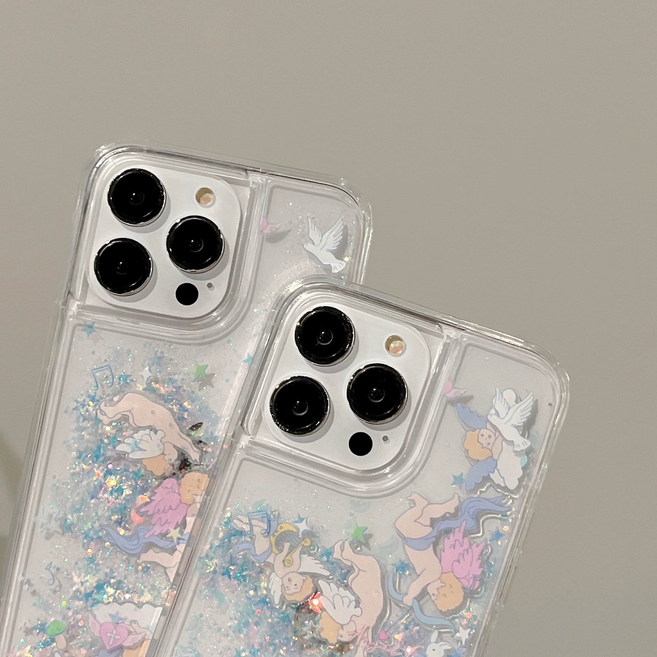 Pair of iPhone 13 Pro Max cases with floating glitter and avian motif