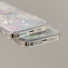 Display of two Y2K-inspired glittery phone cases for iPhone 14 and 13 series