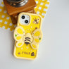 Close-up of a yellow iPhone case featuring bee and floral embellishments