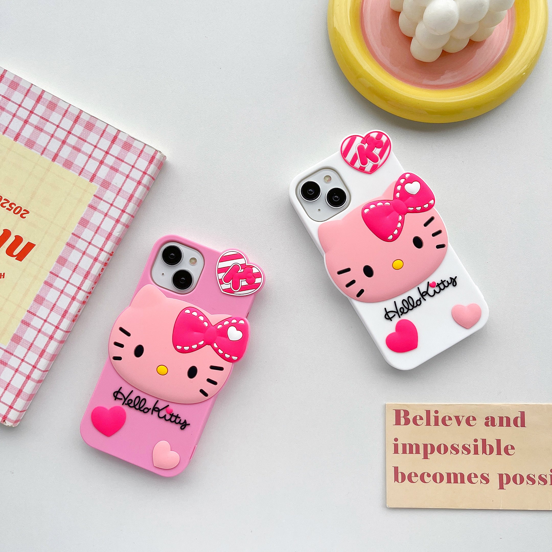 Shockproof Hello Kitty case for iPhone against a pink and white setting