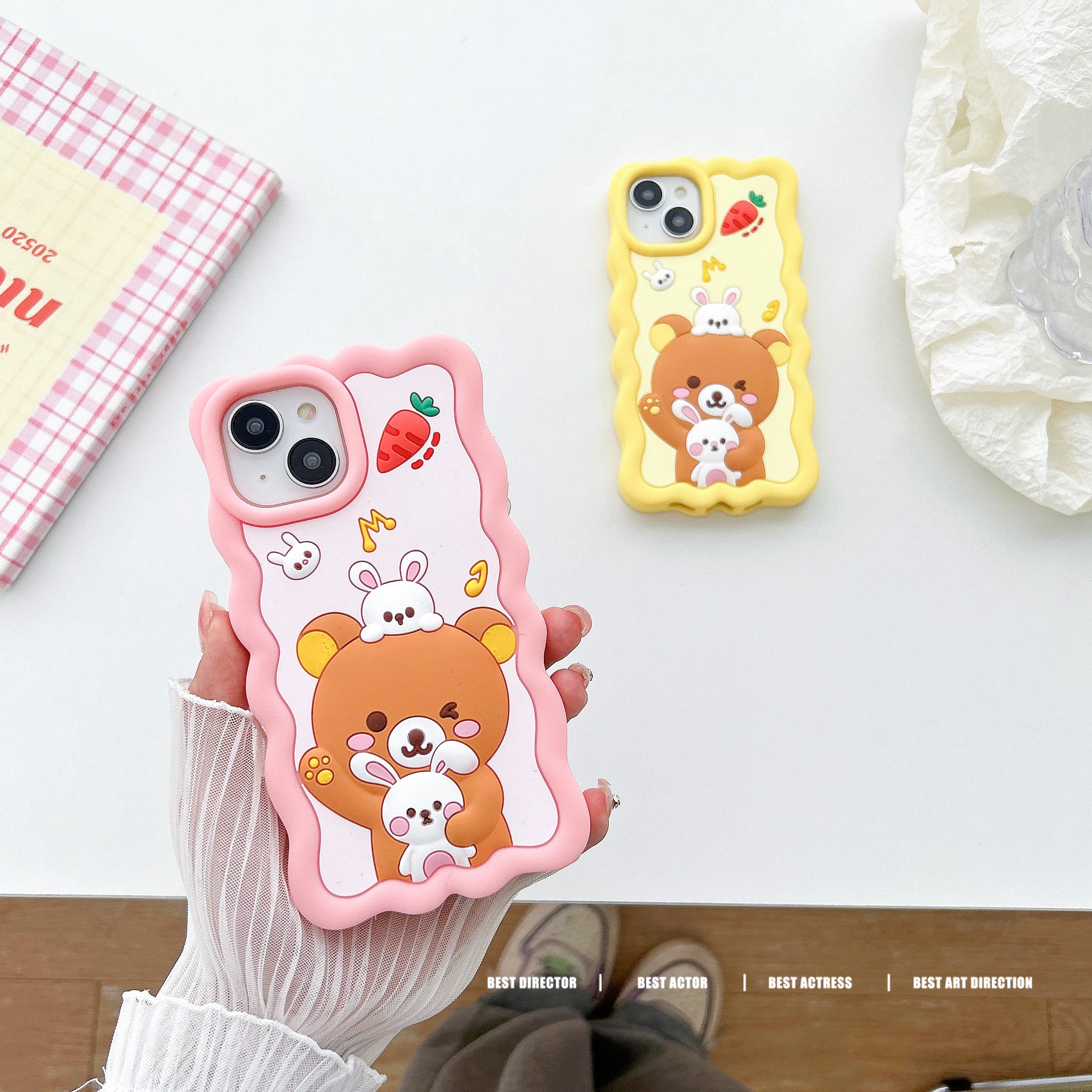 Close-up of a hand gripping a kawaii bear-themed iPhone case suitable for iPhone 14 Pro Max