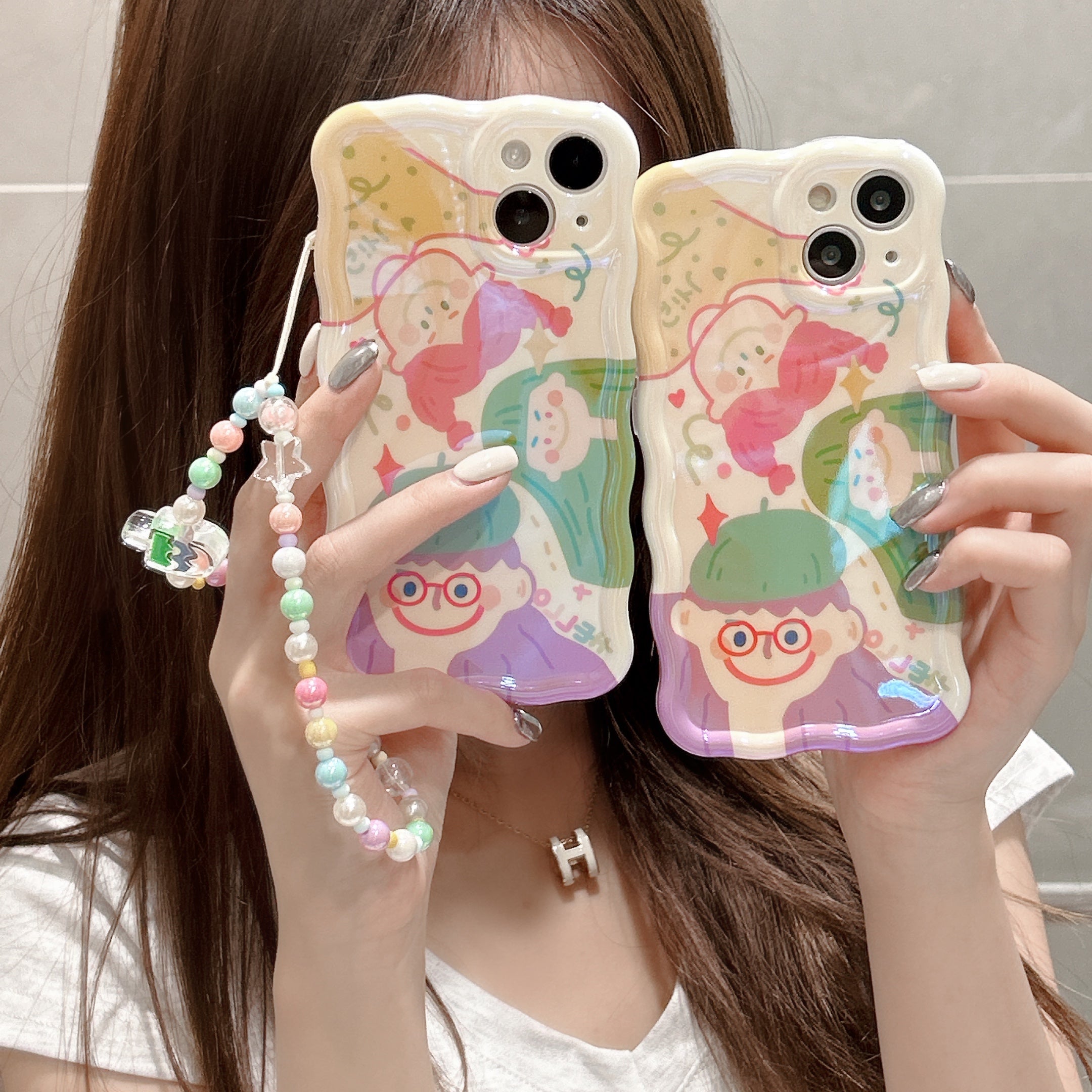 Fashionable girl presenting two pastel iPhone cases with charming cartoon motifs