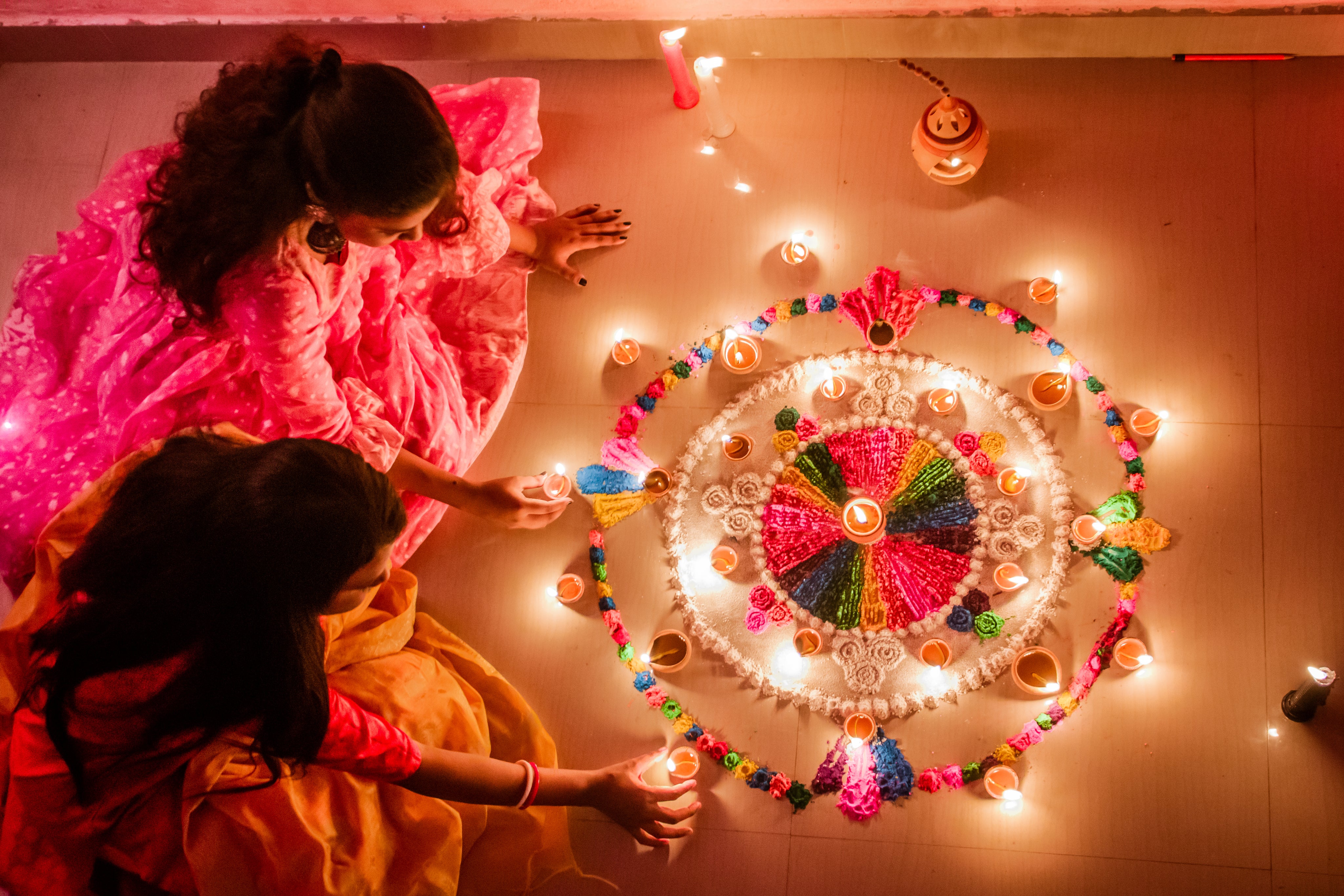 two-young-women-arrange-candles.jpg